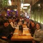 International Student Society members enjoying a dinner at a vibrant restaurant in Galway.